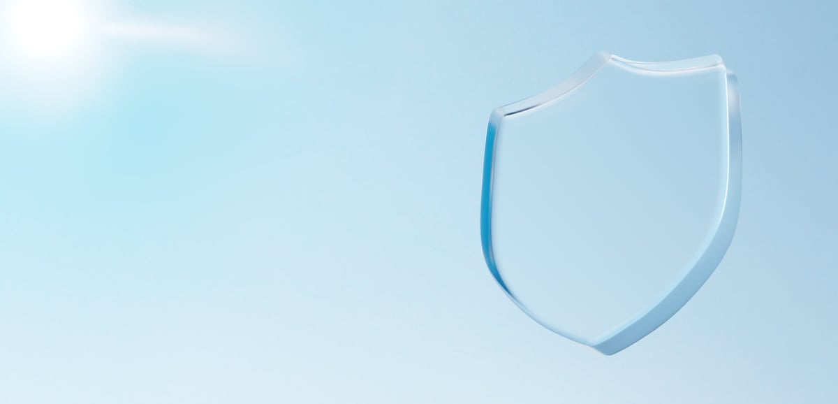 Transparent glass shield against blue sky representing signal blocking technology